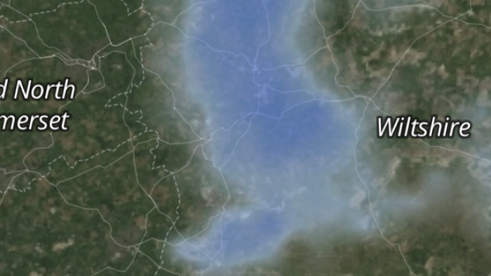 Old radar map rendering — soft, blurred precipitation blobs over the satellite base